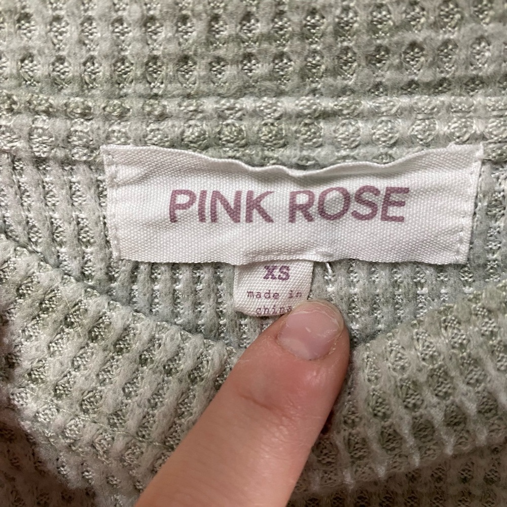 A sweater. The brand is pink rose. XS greenish grey.